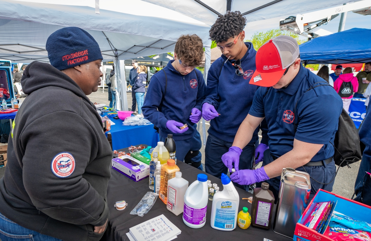 Students take part in a hands-on activity at an outdoor event. 
