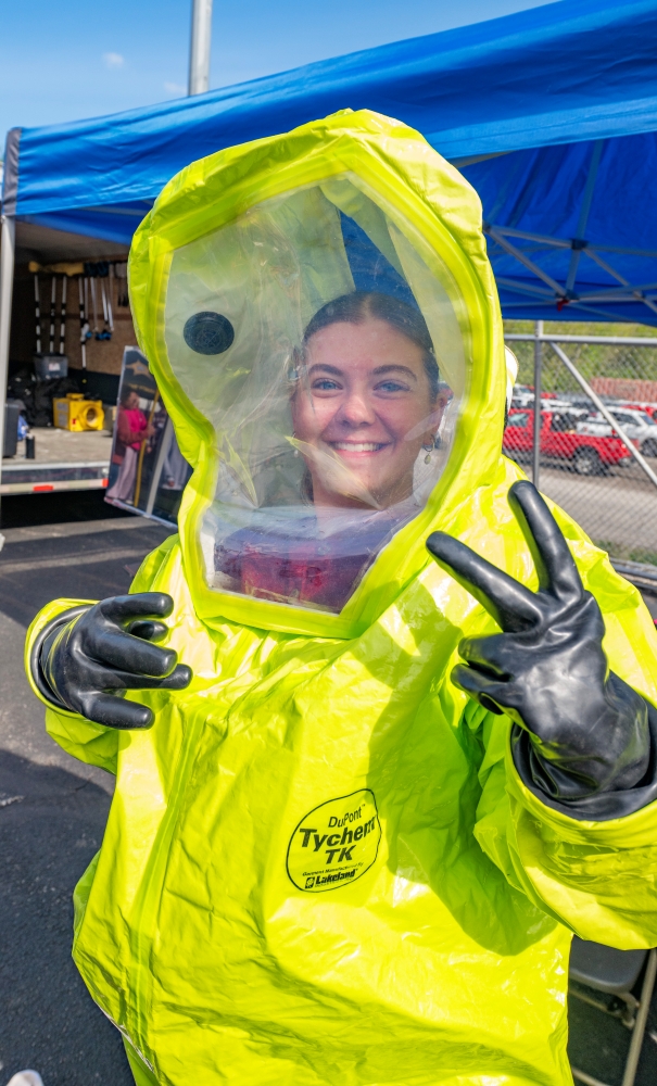 A student tries on a hazmat suit during the Field Day event.
