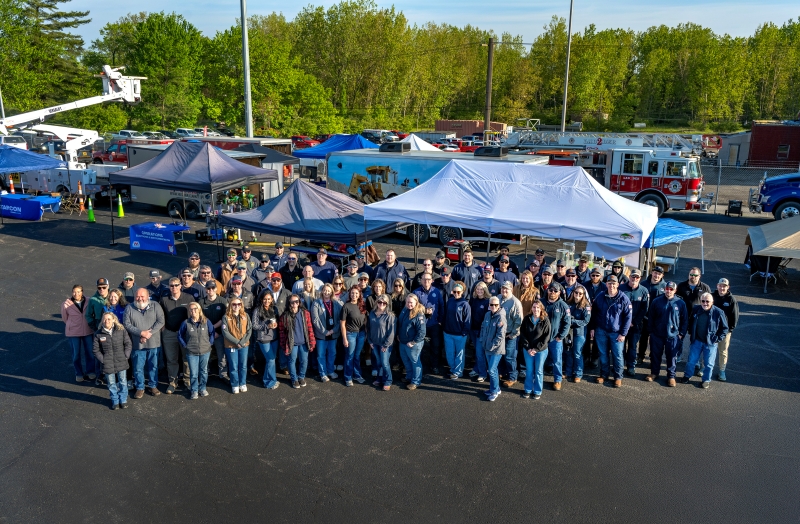 A large group of people pose together for a photo taken from above.
