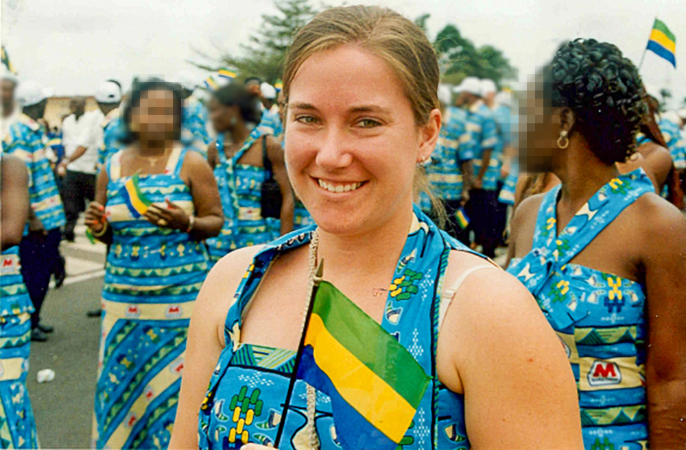  Jenn Buzaleski holding a Gabon flag with other people in colorful dresses.