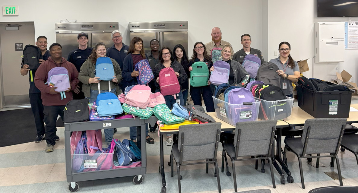 A group of people with lots of colorful backpacks. A group of people with lots of colorful backpacks.