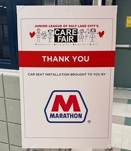 A sign that says Junior League of Salt Lake City’s CARE FAIR. Thank you. Car seat installation brought to you by Marathon. A sign that says Junior League of Salt Lake City’s CARE FAIR. Thank you. Car seat installation brought to you by Marathon.