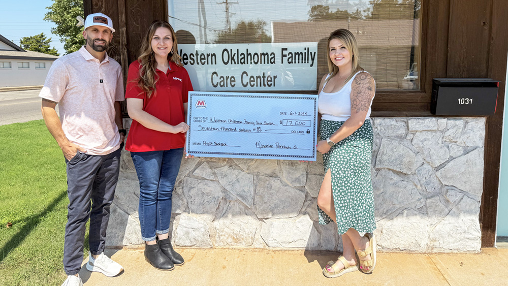 Three people with a large grant check outside the Western Oklahoma Family Care Center building. Three people with a large grant check outside the Western Oklahoma Family Care Center building.