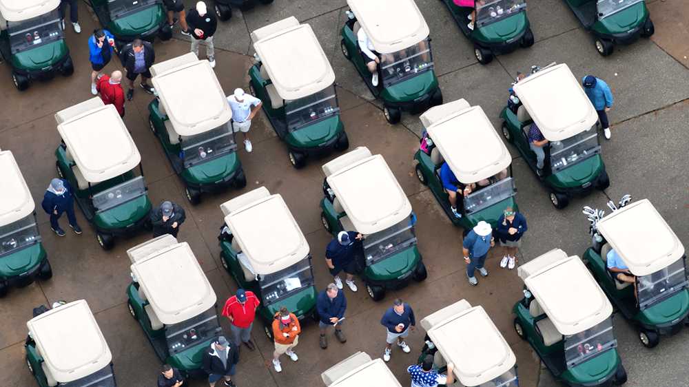 An aerial view of golf carts lined up.