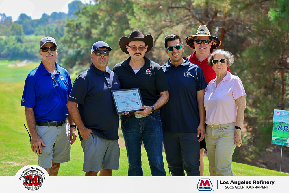 Six people hold a plaque on a golf course.