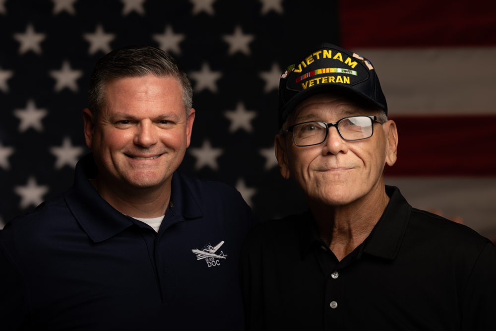 Two men standing together for a photo.
