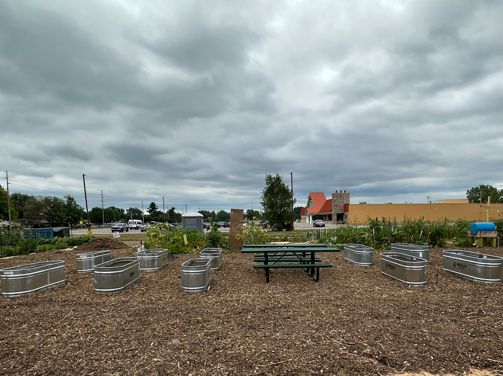 Raised garden beds filled with growing plants are pictured at a community garden during the summer growing season.