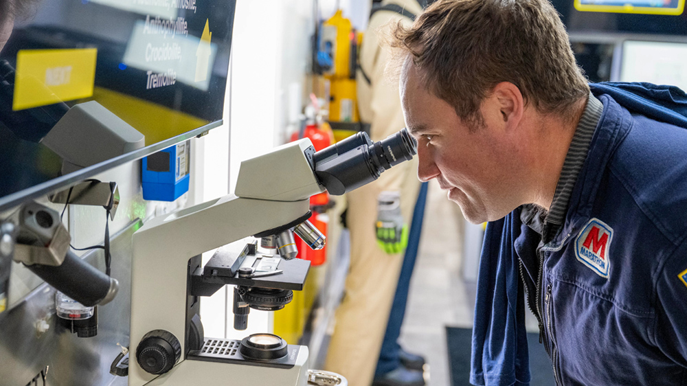 Man looks into a microscope.