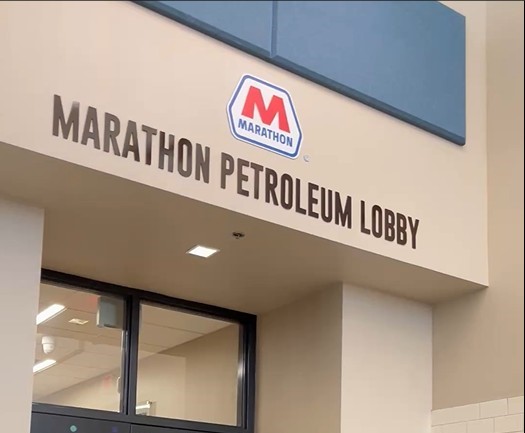 Wording and a logo over a doorway inside a building.