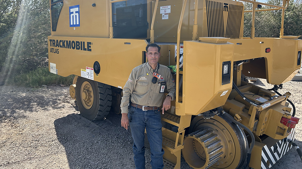 Man stands by a Trackmobile.