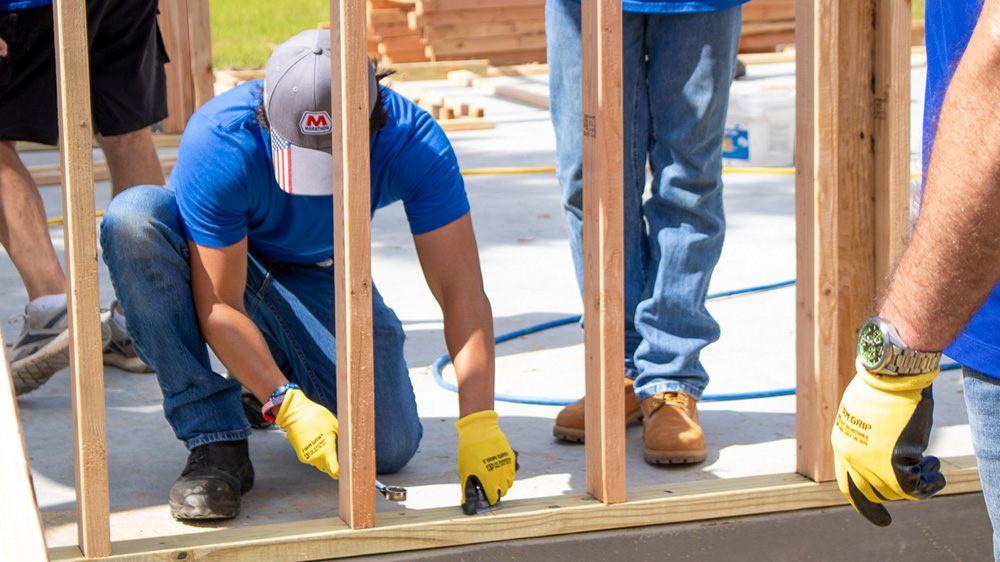 Volunteers working together at a construction site.