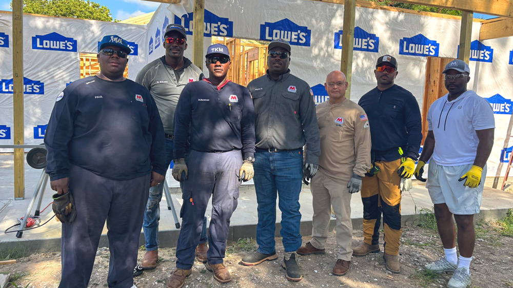 Volunteers gathered at a construction site.