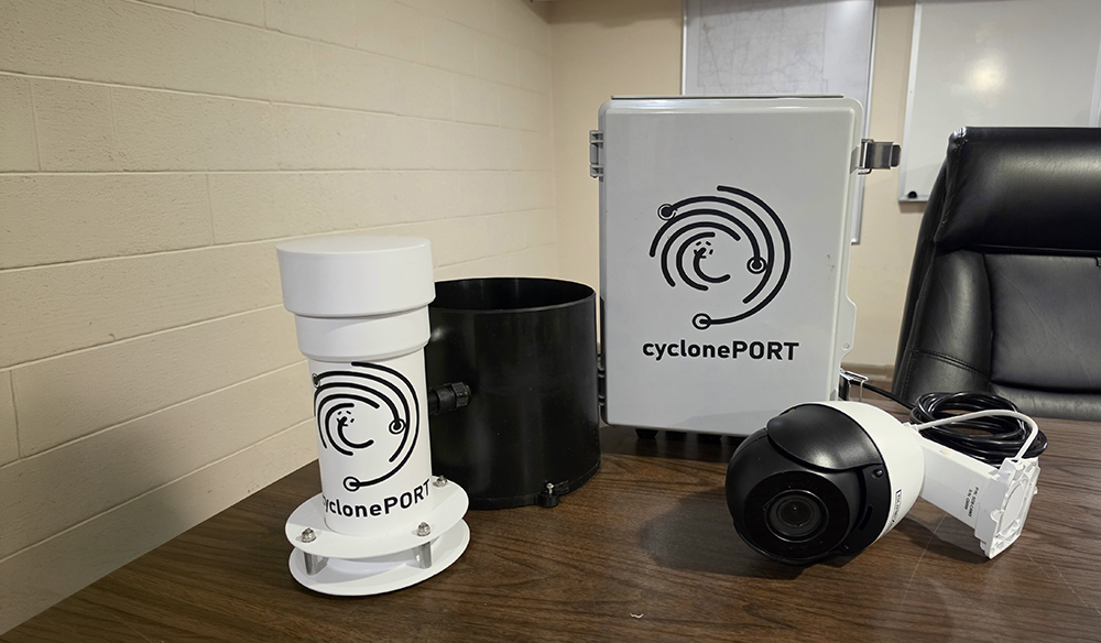 Advanced weather monitoring system equipment displayed on a table, including a camera and monitoring devices.