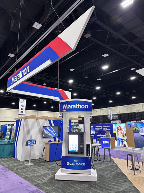 Marathon fuel pump display beneath overhead Marathon signage at a tradeshow booth.