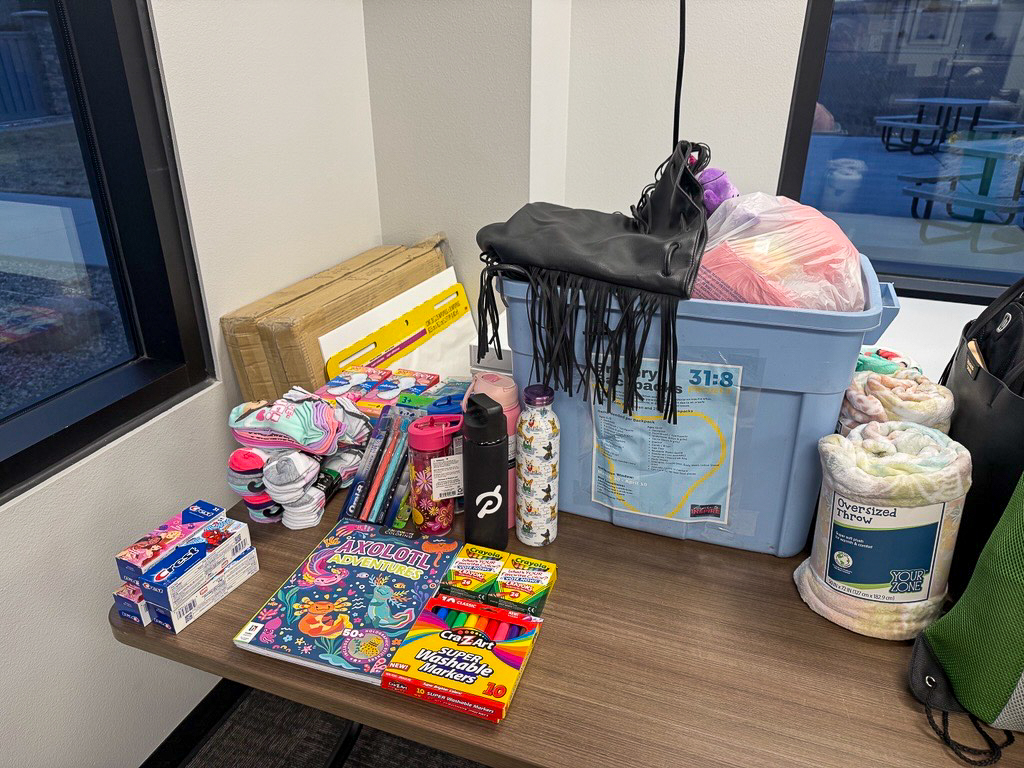 Assorted donated items, including backpacks and supplies, on display.