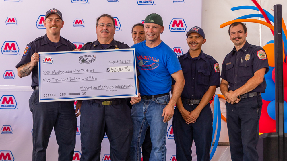 A group of people with a large check for $5,000 to the Montezuma Fire District. A group of people with a large check for $5,000 to the Montezuma Fire District.