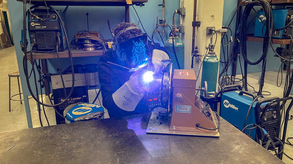 A young man welding metal. 