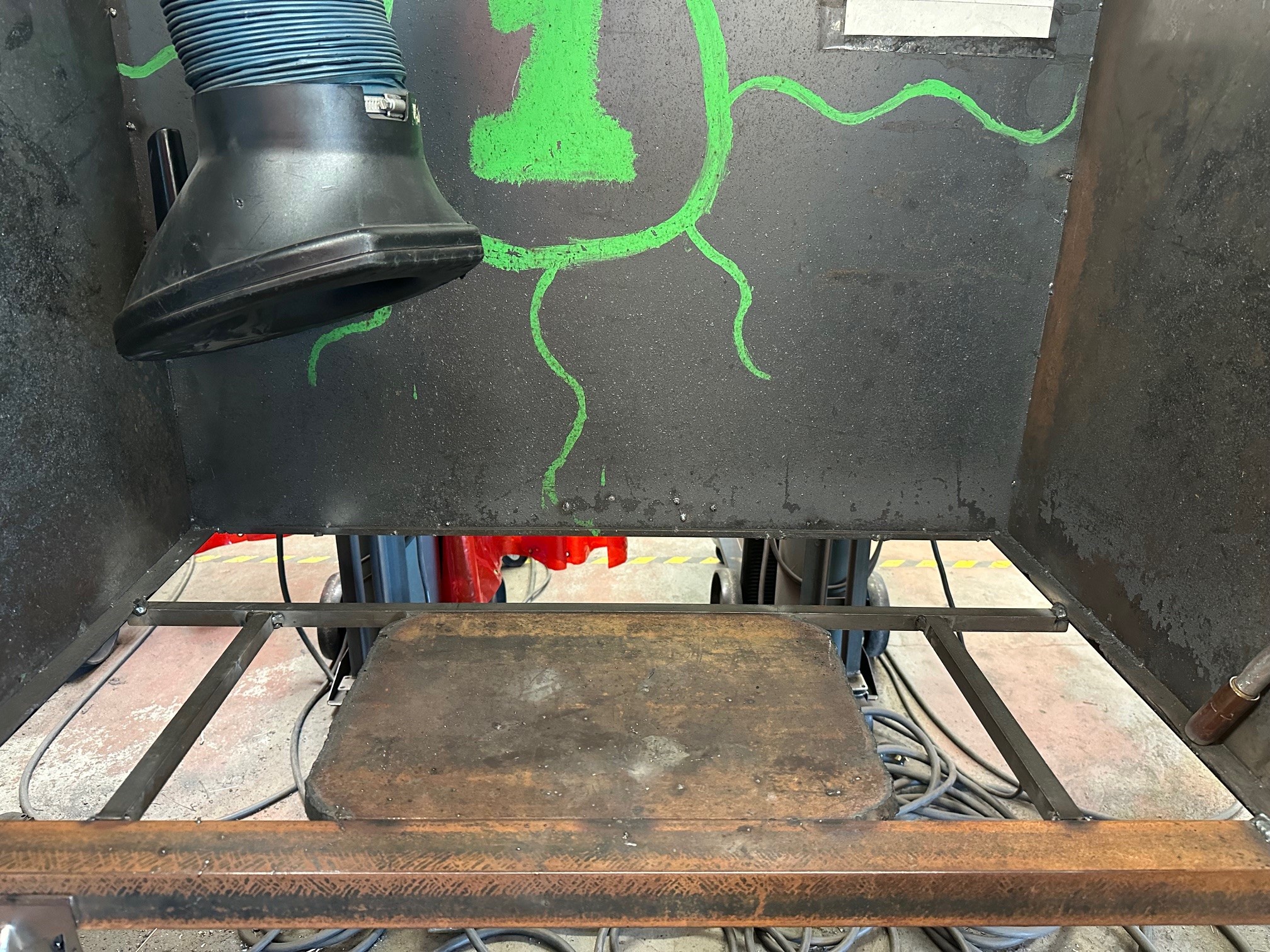 The walls and flat surface of a welding booth. 