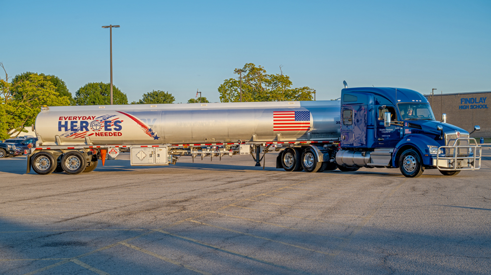 A truck and trailer parked in a parking lot.