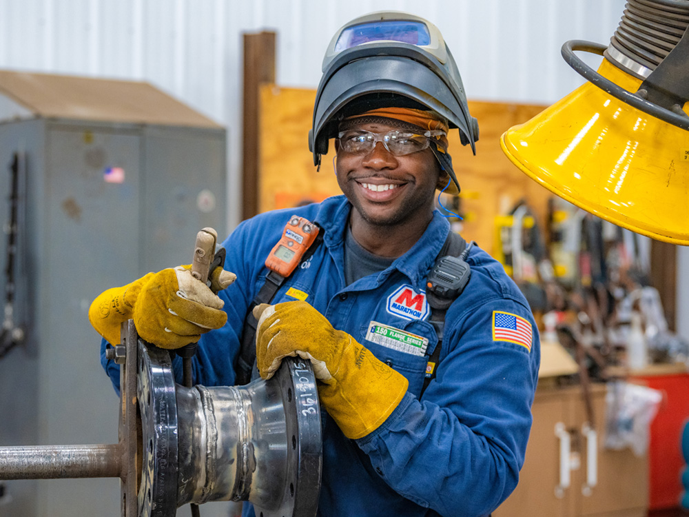A skilled employee signaling thumbs up after a task has been completed A skilled employee signaling thumbs up after a task has been completed