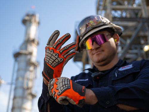 MPC Refining employee inspecting his gloves